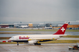 Plane taxiing under gray skies