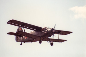 Vintage biplane soaring through a clear sky
