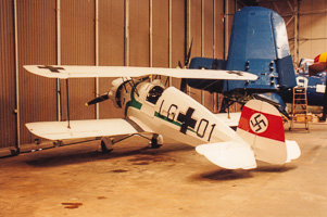 Vintage aircraft displayed in an aviation hangar